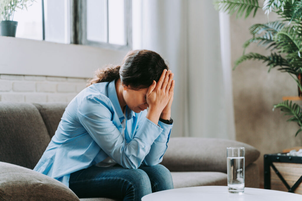 Woman grieving in a couch.