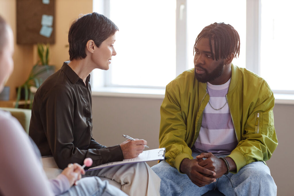 Psychologist talking to a man.