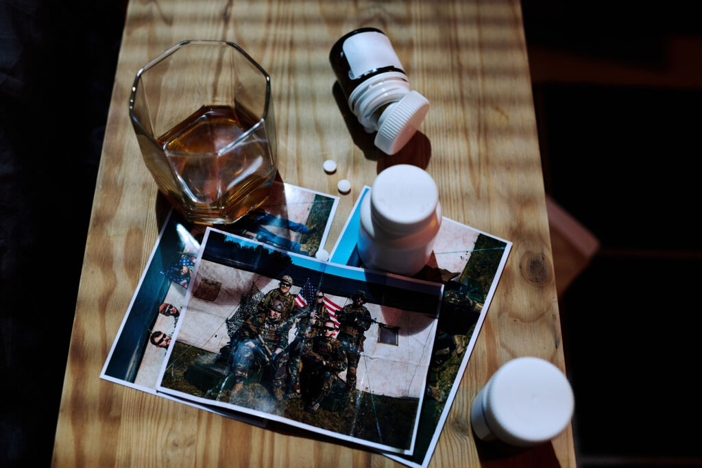 Above view of a photo of military with alcohol and pills.