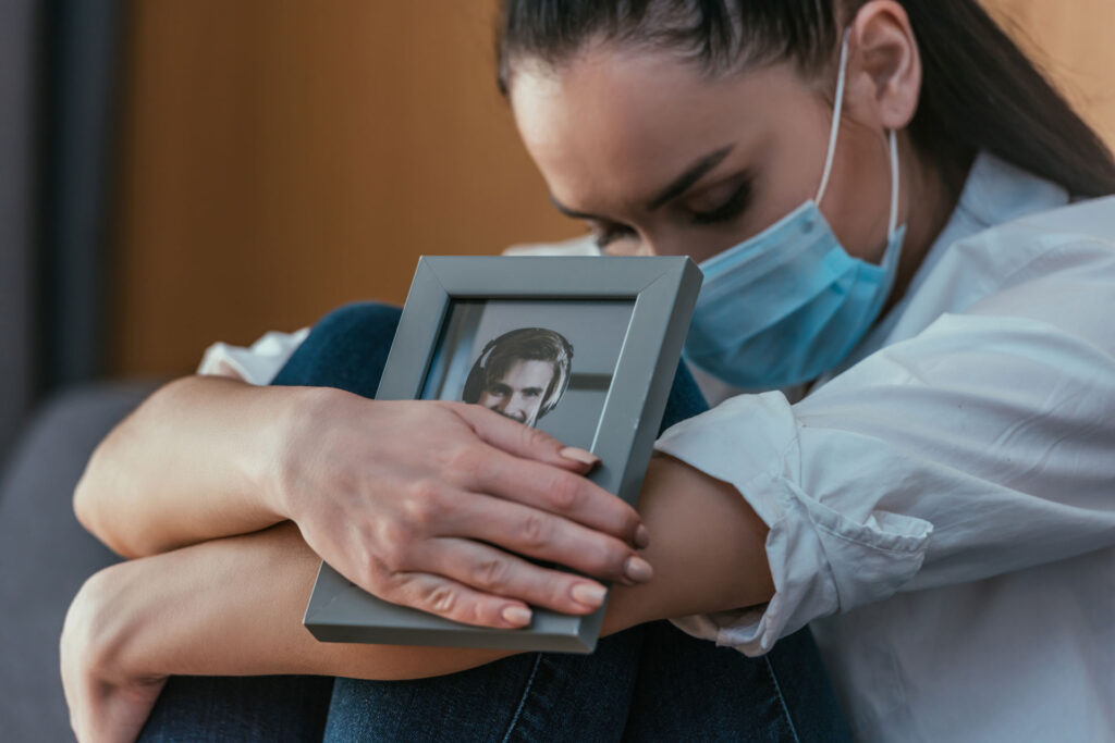 Grieving woman holding a photo of a man.