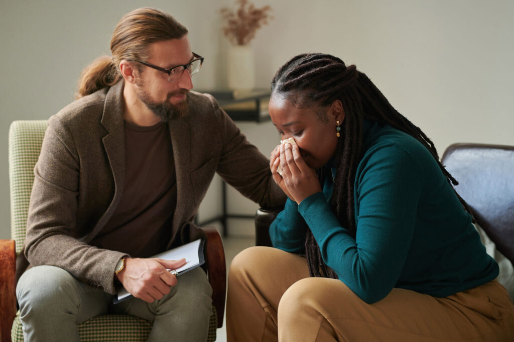 Therapist comforting her grieving client.