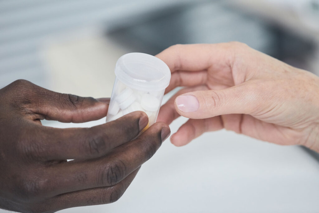 Man giving opioid pills to a woman.