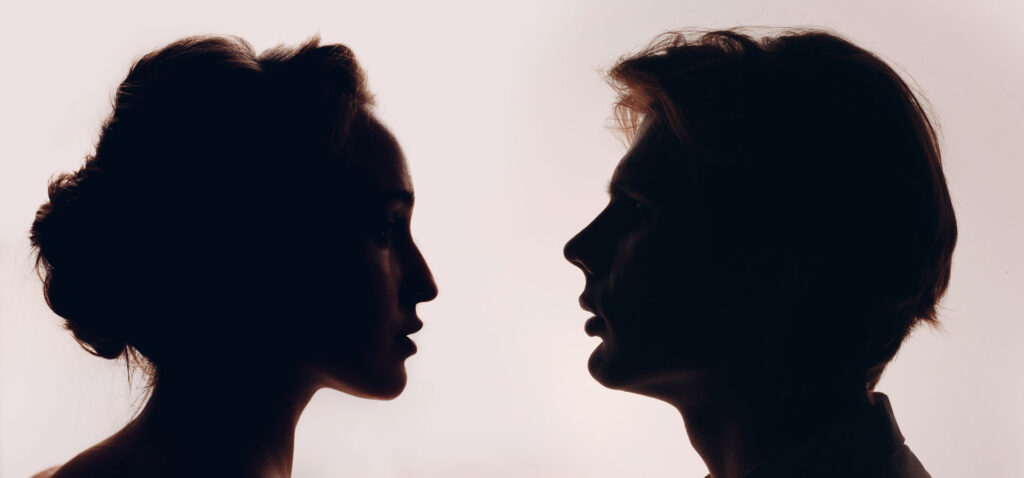 Man and woman facing each other.