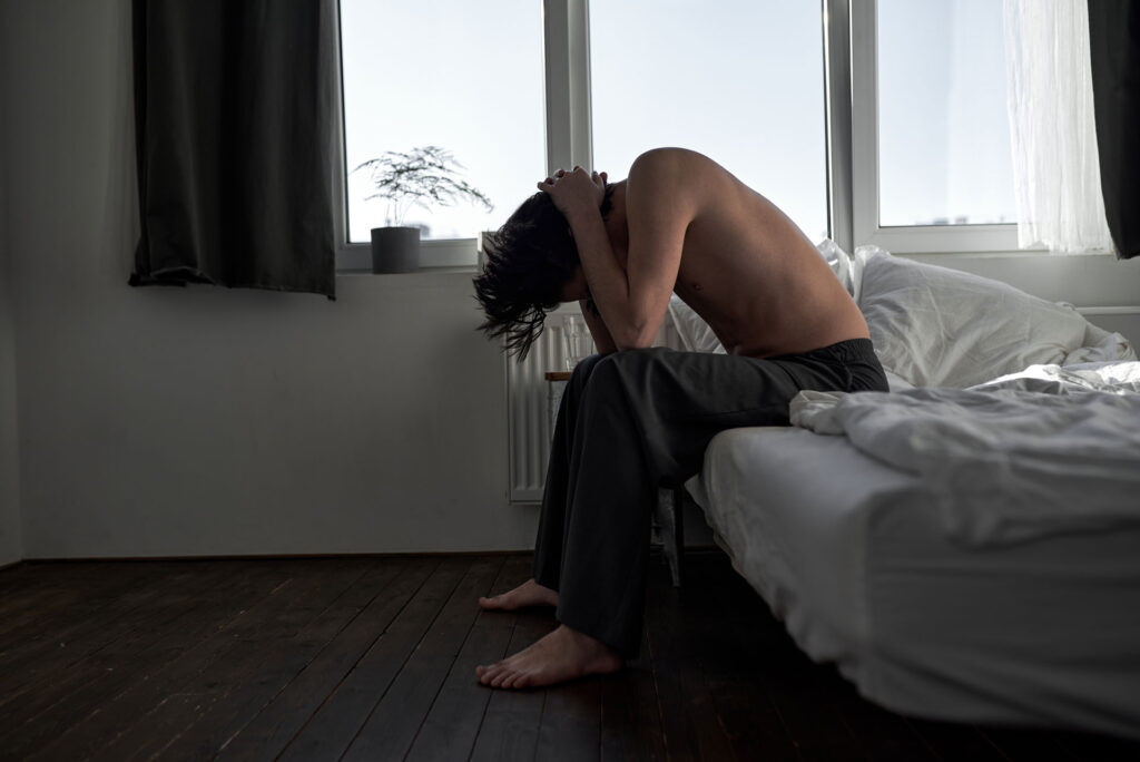 Depressed man in his bed.