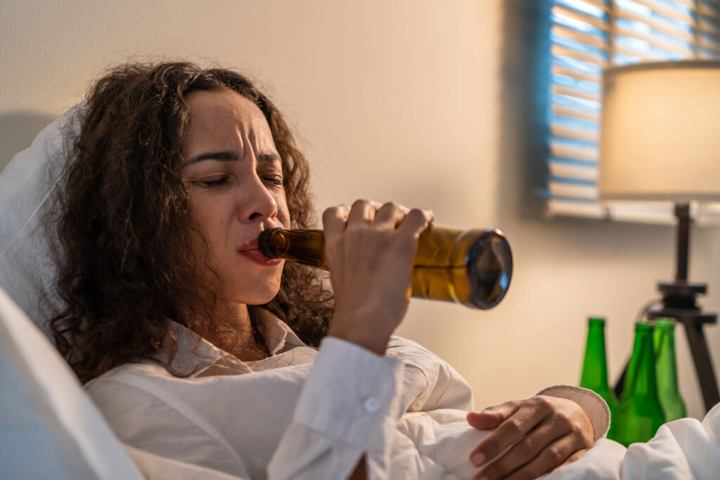 Drunk woman holding a beer.