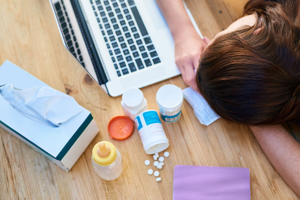 A person sleeping in table together with medicines.