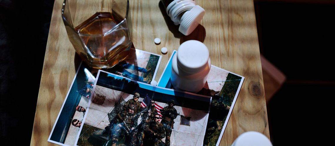 Above view of a photo of military with alcohol and pills.