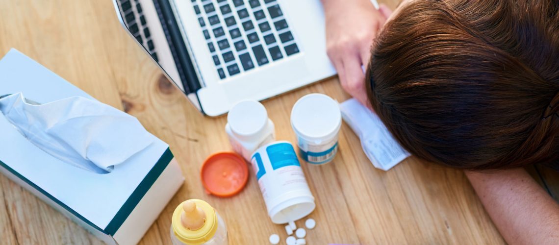 A person sleeping in table together with medicines.